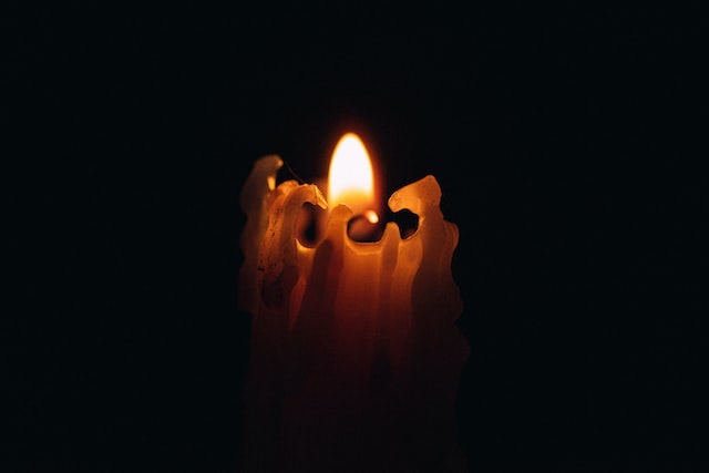 A candle burning in the dark